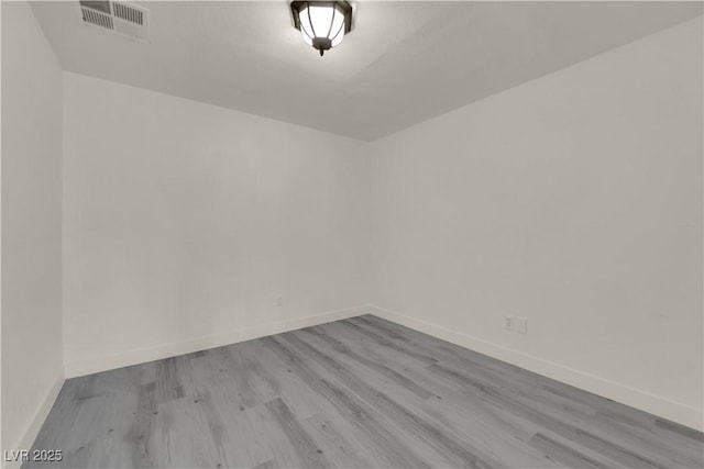 unfurnished room with light wood-type flooring