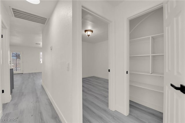 hallway with light hardwood / wood-style flooring