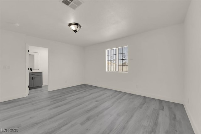 spare room with light hardwood / wood-style floors