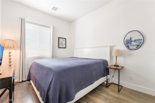 bedroom featuring dark hardwood / wood-style flooring