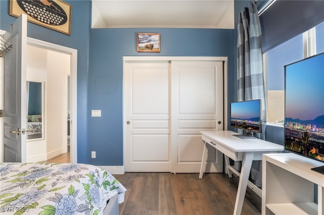 bedroom with a closet and dark hardwood / wood-style flooring