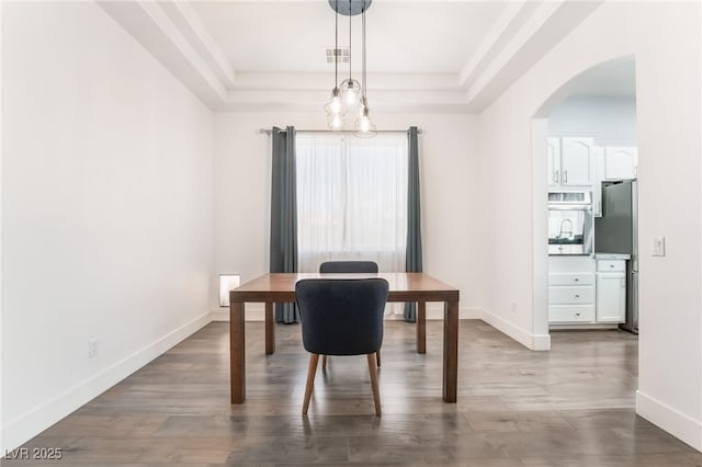 office area featuring hardwood / wood-style flooring and a raised ceiling