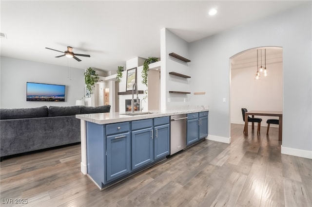 kitchen featuring decorative light fixtures, stainless steel dishwasher, ceiling fan, and blue cabinetry