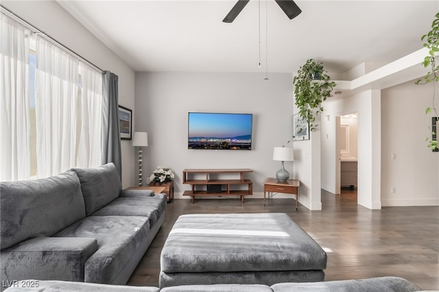 living room featuring ceiling fan, a healthy amount of sunlight, and dark hardwood / wood-style floors