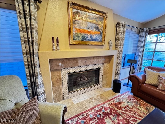 living area featuring a fireplace and vaulted ceiling