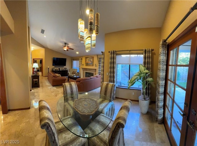 dining space featuring vaulted ceiling and ceiling fan