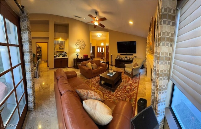 living room with lofted ceiling, ceiling fan, and a wealth of natural light