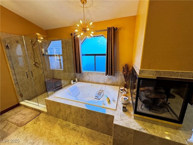 bathroom with shower with separate bathtub and a chandelier