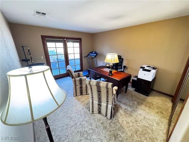 carpeted home office featuring french doors