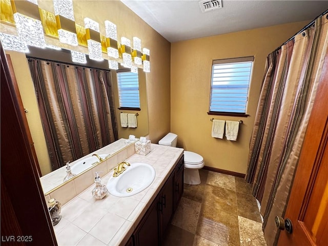 bathroom with toilet and vanity