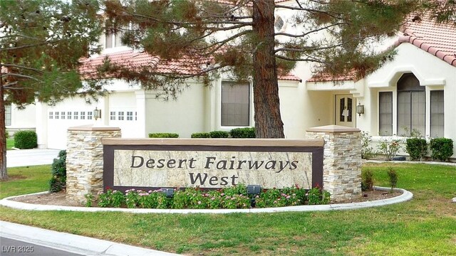 community sign featuring a lawn