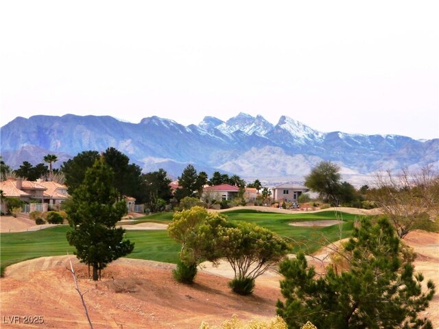 view of property's community with a yard and a mountain view