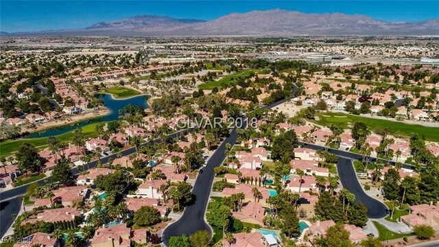 drone / aerial view with a water and mountain view