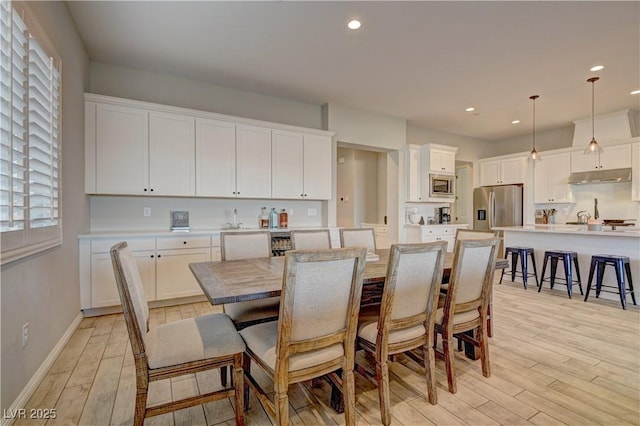 dining room featuring light wood-type flooring and a wealth of natural light