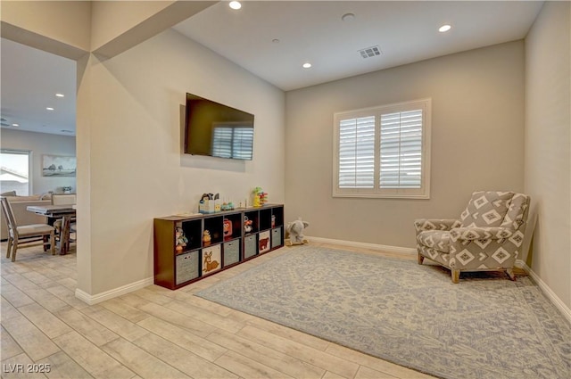 sitting room with a wealth of natural light and light hardwood / wood-style flooring