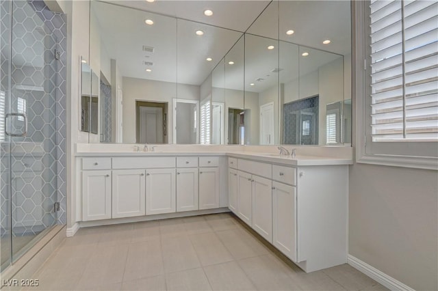 bathroom featuring vanity, tile patterned floors, and a shower with shower door