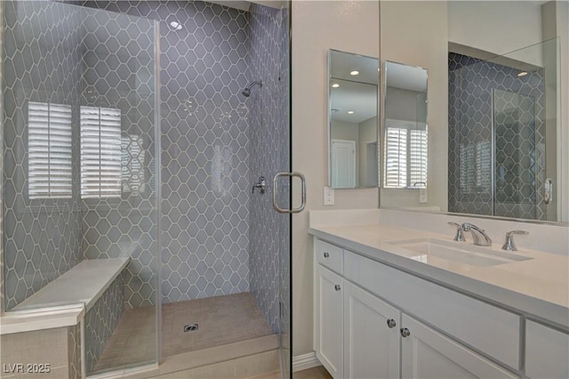 bathroom with walk in shower and vanity