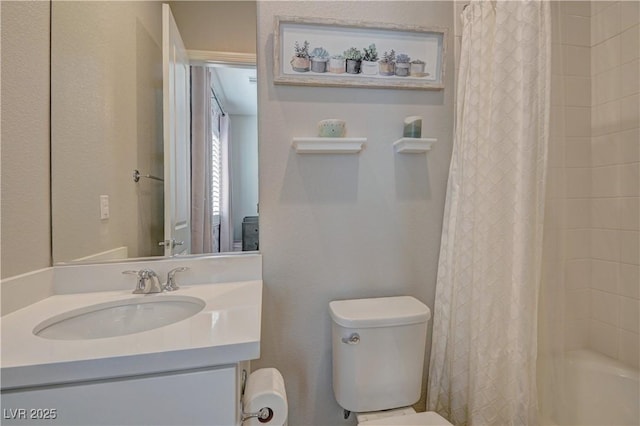 full bathroom featuring shower / bath combo, vanity, and toilet