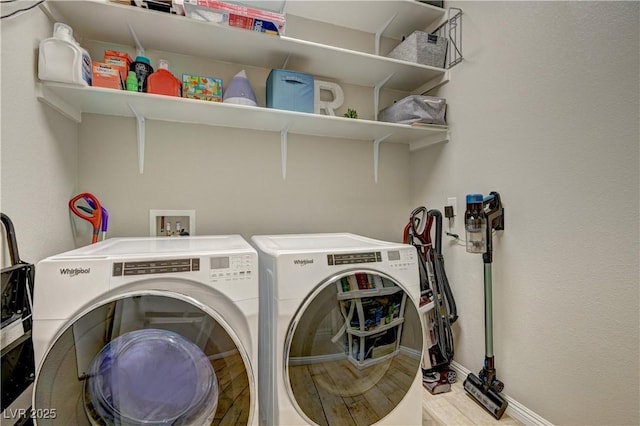 clothes washing area featuring independent washer and dryer