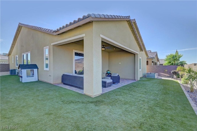 back of property featuring central air condition unit, a patio, a lawn, ceiling fan, and outdoor lounge area