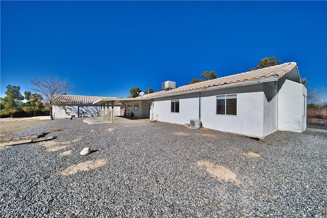 back of property with cooling unit and ac unit