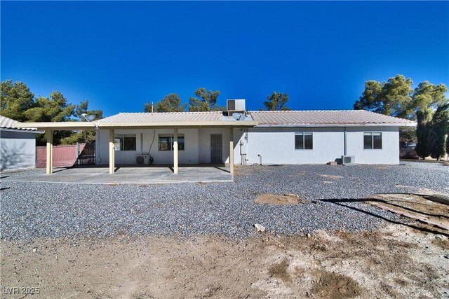 rear view of property featuring cooling unit and a patio area