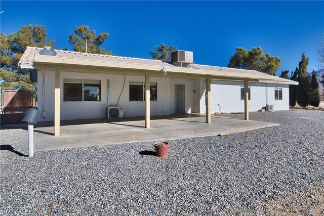 rear view of house with ac unit, a patio, and central air condition unit