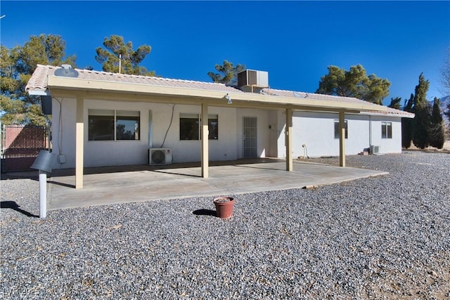 back of house featuring ac unit, a patio area, and central air condition unit