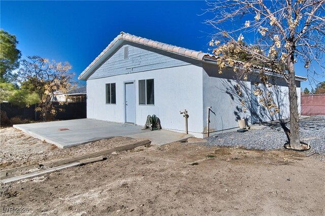 rear view of property featuring a patio area