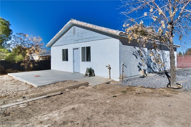 back of house with a patio