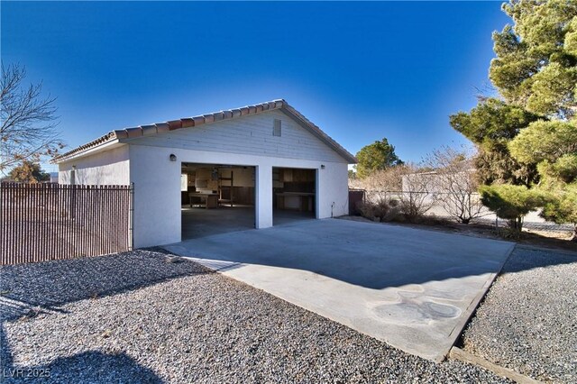 view of property exterior with a garage and an outdoor structure