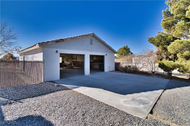 view of home's exterior with a garage and an outbuilding