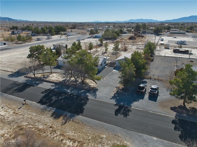 birds eye view of property featuring a mountain view