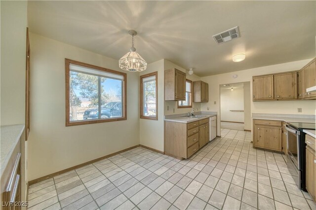 kitchen with electric range, pendant lighting, dishwasher, and sink