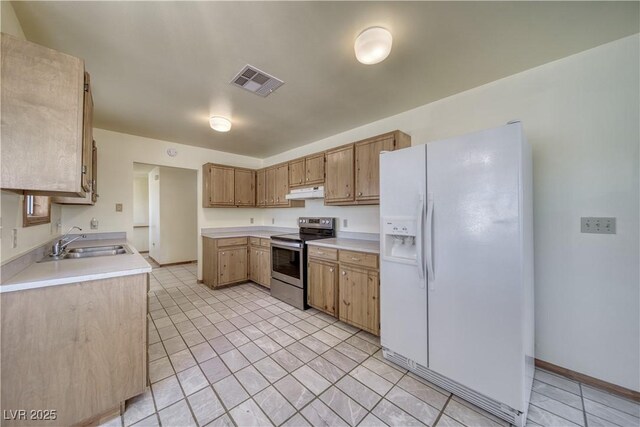 kitchen with white fridge with ice dispenser, stainless steel range with electric stovetop, and sink