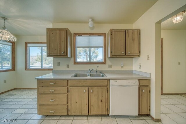 kitchen featuring white dishwasher, light tile patterned flooring, and sink