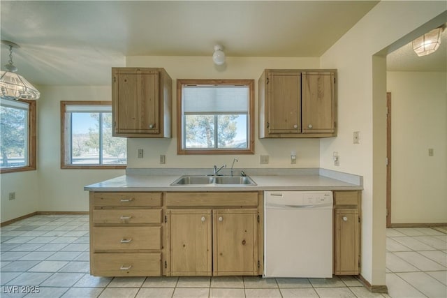 kitchen with white dishwasher, decorative light fixtures, sink, and light tile patterned floors