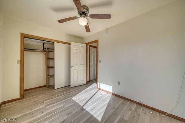 unfurnished bedroom featuring light wood-type flooring, ceiling fan, and a closet