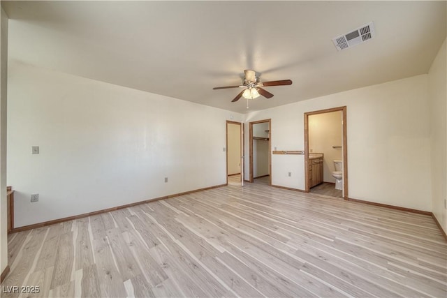 unfurnished bedroom featuring connected bathroom, light hardwood / wood-style floors, and ceiling fan