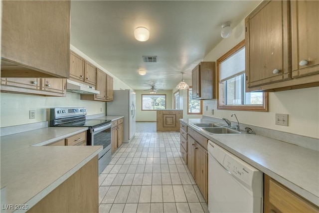 kitchen featuring sink, refrigerator with ice dispenser, dishwasher, hanging light fixtures, and stainless steel electric stove