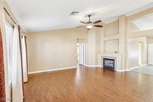 unfurnished living room featuring ceiling fan, vaulted ceiling, and hardwood / wood-style flooring