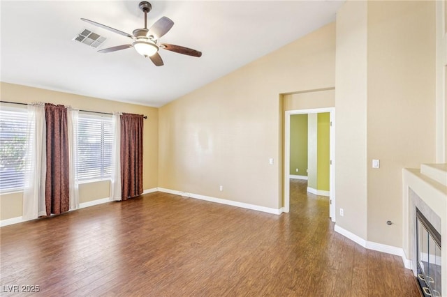 unfurnished living room featuring ceiling fan, dark wood-type flooring, and lofted ceiling