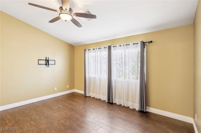 spare room with ceiling fan and dark hardwood / wood-style floors