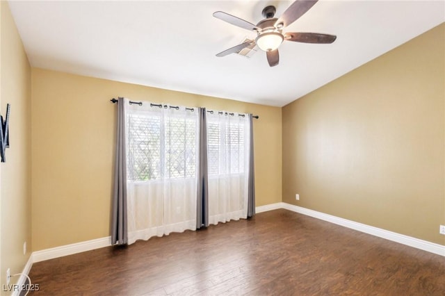 spare room with ceiling fan and dark wood-type flooring