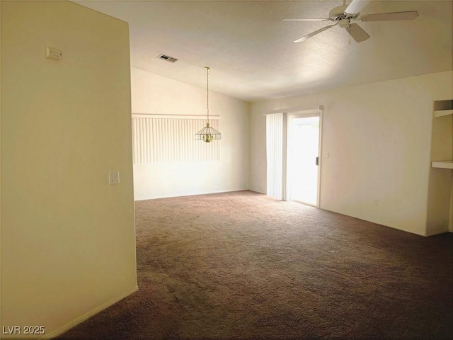 unfurnished room with lofted ceiling, carpet flooring, and ceiling fan with notable chandelier