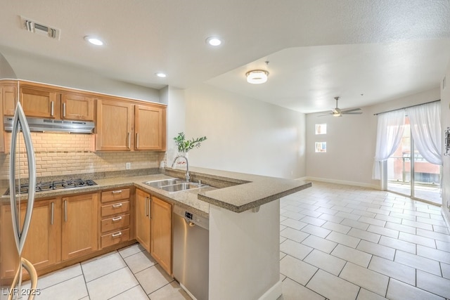 kitchen with kitchen peninsula, stainless steel appliances, light tile patterned floors, ceiling fan, and sink