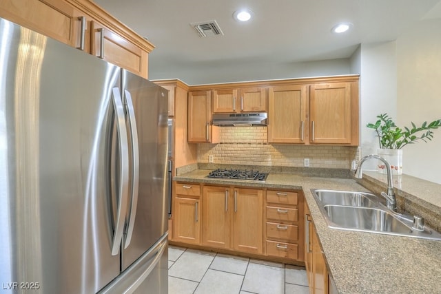 kitchen featuring sink, stainless steel appliances, backsplash, and light tile patterned floors