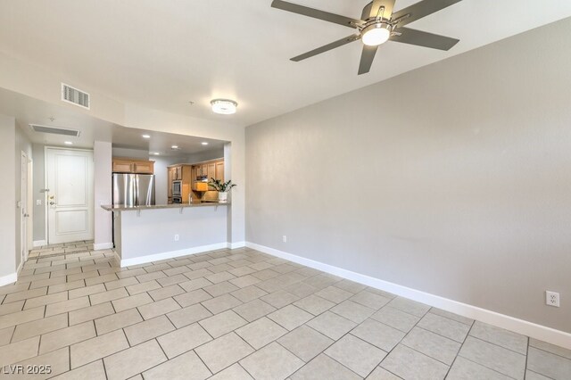 interior space featuring ceiling fan and light tile patterned floors