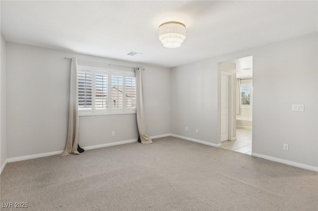 unfurnished room featuring light carpet