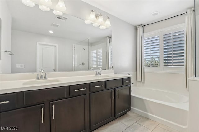 bathroom with vanity, tile patterned flooring, and plus walk in shower